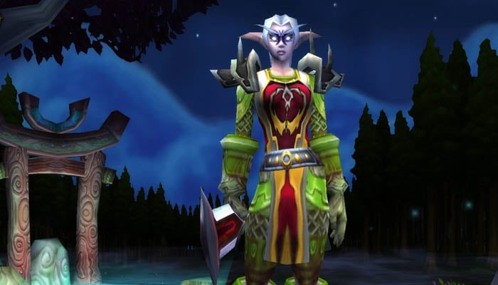 A night elf hunter standing in the woods in World of Warcraft Classic